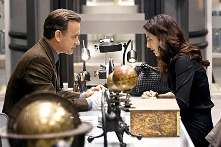 In <i>Angels & Demons</i>, Tom Hanks, as Robert Langdon, and Ayelet Zurer, as Vittoria Vetra, race to thwart a plot against the Vatican.