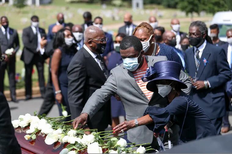Family members place flowers on the casket of Rep. John Lewis during the burial service at South-View Cemetery in Atlanta.