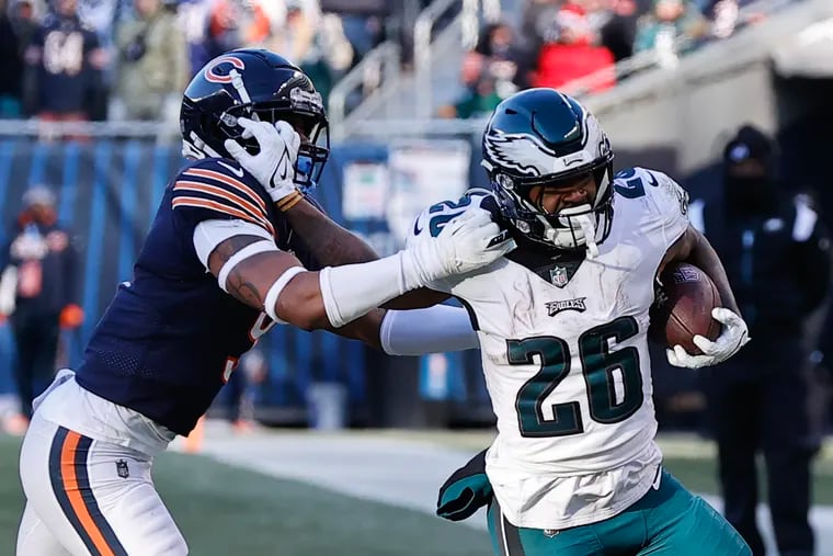 Eagles running back Miles Sanders stiff-arms Bears safety Jaquan Brisker during the fourth quarter on Sunday.