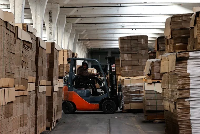 Fork lift operator Rafael Esquilin of Hunting Park moves pallets of recycled boxes inside the Impact Recycling Partners factory in the Hunting Park neighborhood of North Philadelphia.