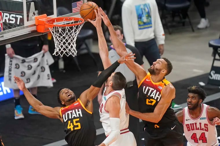 Utah Jazz's Rudy Gobert (27) and Donovan Mitchell (45) defending against Chicago Bulls center Nikola Vucevic in the first half of last Friday's game.