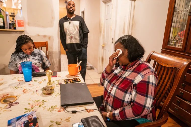 (Left to Right) Anieka Miller, Michael Miller Sr, and Nicole Miller, the parents and sister of Michael Miller Jr., who was killed in Queen Village in October, talk with an Inquirer reporter at their home in Philadelphia, Friday, December 22, 2023.