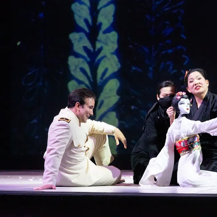 In Opera Philadelphia's production of Puccini's 'Madame Butterfly,' Cio Cio San (Karen Chia-Ling Ho) with puppet; Pinkerton (Anthony Ciaramitaro); and puppet artist Hua Hua Zhang.