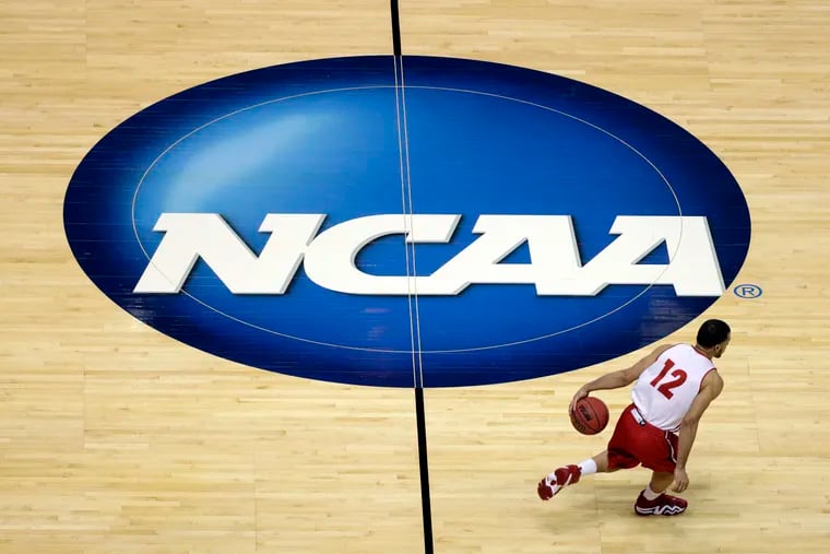 Wisconsin's Traevon Jackson dribbles past the NCAA logo during practice at the NCAA Tournament in 2014.