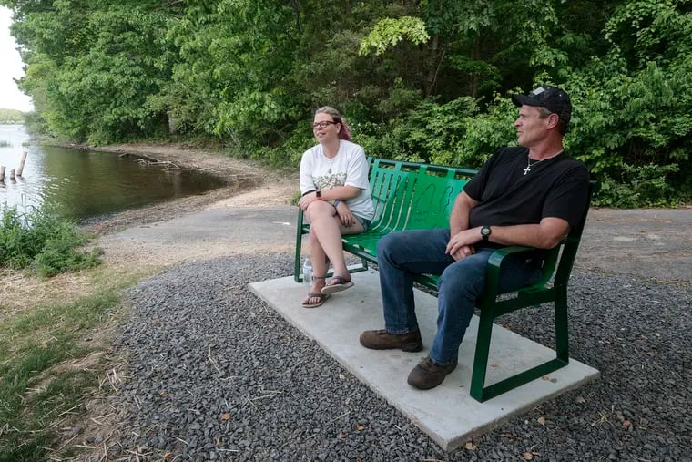 Jason Kutt was killed in 2020 when a hunter accidentally shot him as he sat with his girlfriend by Lake Nockamixon. His parents, Dana and Ron, seen here in May 2021, dedicated this bench to him at the site of his death.