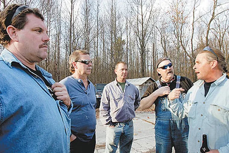 Contract workers (from left) Glenn Hash, 47; Bill Dorman, 54; Jim Pribish, 47; Jerry Gallagher, 57; and Bob Lyon, 46, a contract pipefitter, commiserate in the parking lot of The Red Lion Inn in Bear, Del., a few miles from the the closing Valero plant. (Bonnie Weller / Staff Photographer)