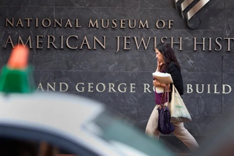 On the first anniversary of the American Jewish History Museum,  a passer-by walks in front of the museum. ( Ed Hille / Staff Photographer )