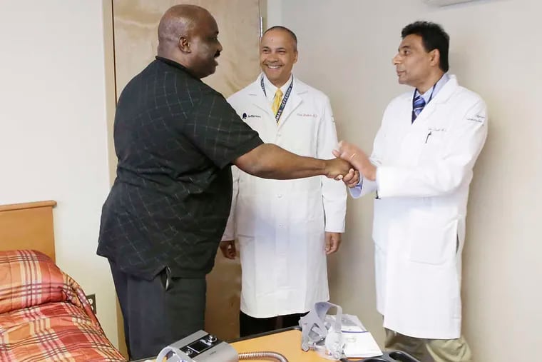 Heart patient Tyrone Conner thanks researchers Paul Mather and Sunil Sharma (right) at the Jefferson Sleep Disorders Center. &quot;I got my life back,&quot; Conner says of the ventilation device.