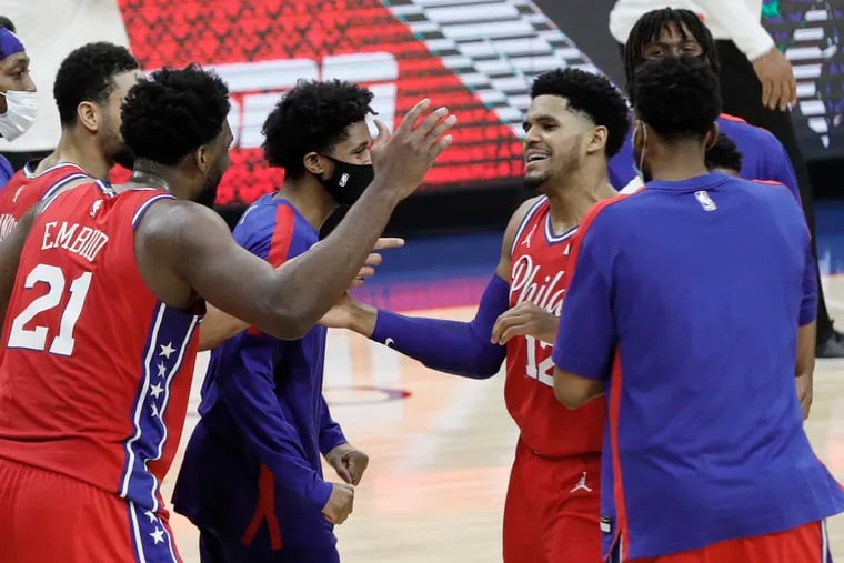 The Sixers celebrate their 107-106 victory over the Lakers by pushing Tobias Harris (12) around after his game-winning shot.