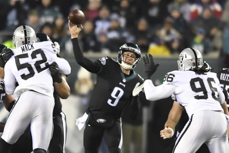 Eagles quarterback Nick Foles passes during the first quarter against the Raiders.