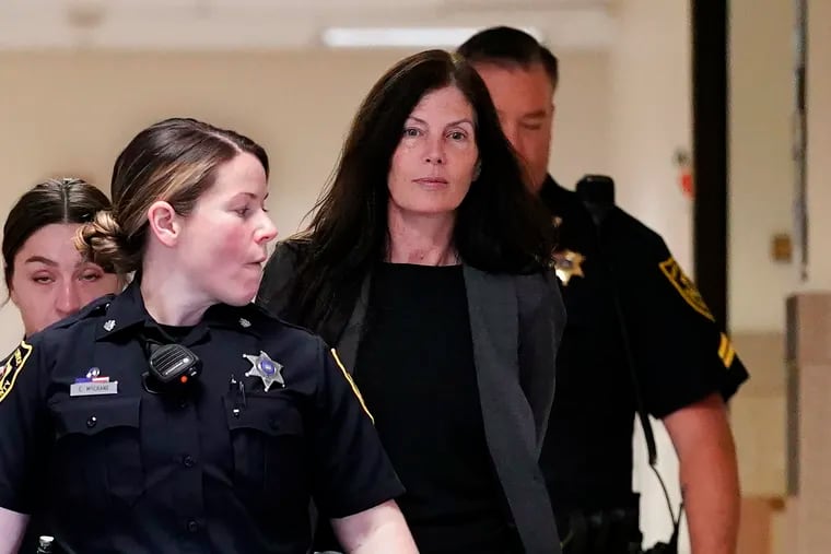 Former Pennsylvania Attorney General Kathleen Kane (center) is led to court as she arrives for a hearing on an alleged probation violation, at the Montgomery County Courthouse in Norristown in May.