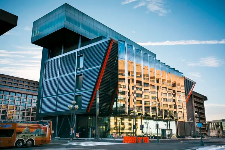 From the outside,  the just-opened   International Spy Museum in Washington reads as an inverted rectangular pyramid, topped by a cantilevered box, with industrial-looking supports anchored into the ground. The exterior metal skin, which the architects call "the veil," is fitted with lights that define its shape at night.