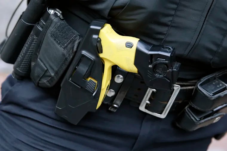 A Philadelphia police officer at the Pennsylvania Convention Center wears a taser on his belt on Nov. 4, 2020.