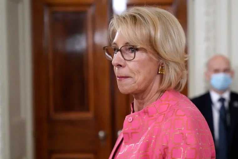 Education Secretary Betsy DeVos arrives for an event in the State Dining room of the White House in Washington.