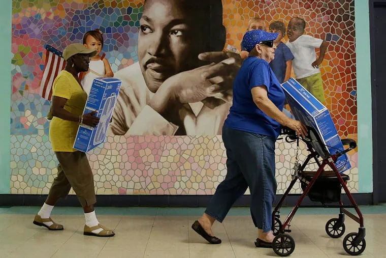 Seniors carry donated fans at the Martin Luther King Older Adult Center in Philadelphia. Older people are more vulnerable in hot weather for a variety of physiological reasons.