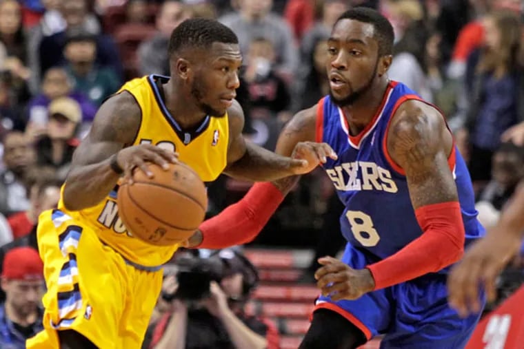 Denver Nuggets' Nate Robinson, left, drives against Philadelphia 76ers' Tony Wroten (8) in the first half of an NBA basketball game Saturday Dec. 7, 2013, in Philadelphia. (H. Rumph Jr/AP)