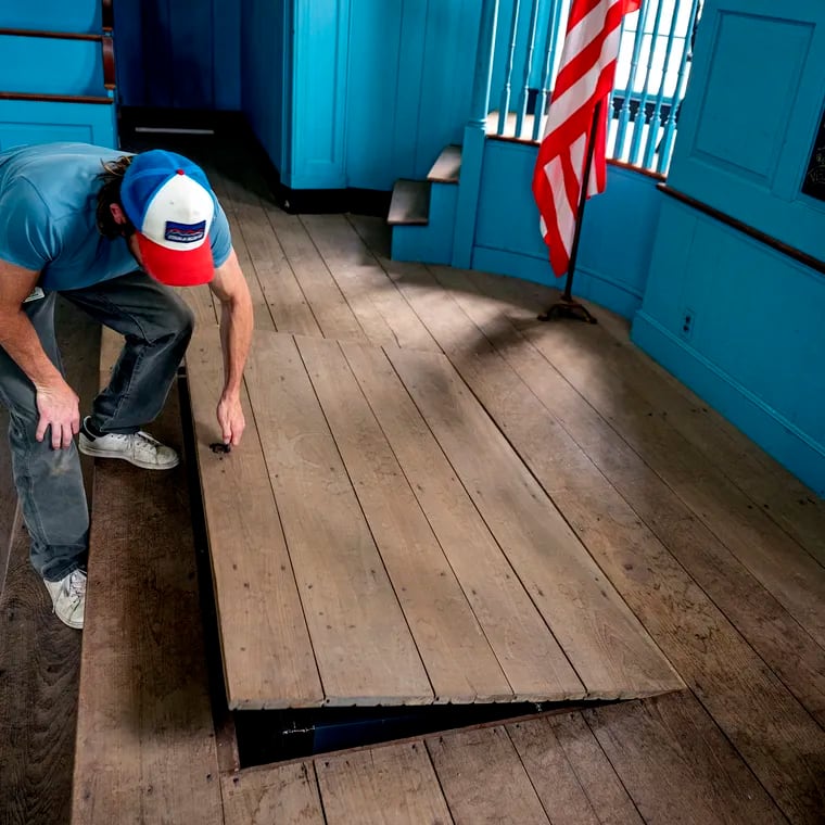 Scott McNeil, a Delaware County facilities manager, peeks into a trap door that covers some of the secrets of the 300-year-old courthouse in the City of Chester, believed to the oldest public building still in use in the country.