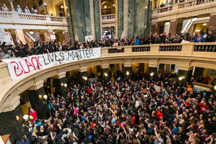 Demonstrators pack the state Capitol in Madison, Wis. A police officer responded to a report Friday evening of someone jumping in and out of traffic and assaulting another person.