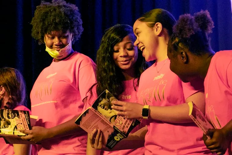 Trinity Martinez (center) laughs along with Gisselle Smith-Echevarria (left), Paris Mears, and Jasmine Robinson (right) last week at Camden High while they look at their new book.Ten Camden students who are part of the “Women of the Dream” program have been published in a book titled “Speak Young Brown People, Speak. We Are Listening!” The book is on Amazon, but the girls are also selling them and keeping the profits for college expenses.
