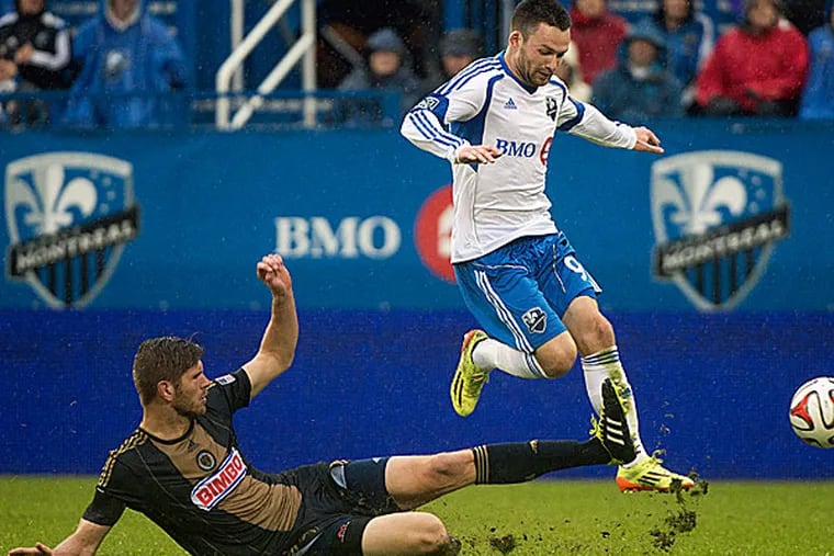 The Impact's Jack McInerney leaps over the Union's Aaron Wheeler. (Graham Hughes/The Canadian Press/AP)