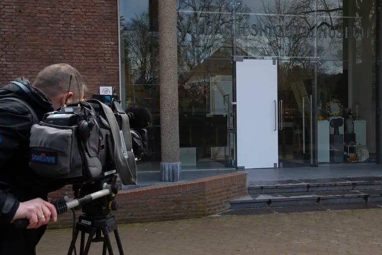 A cameraman films the glass door which was smashed during a break-in at the Singer Museum in Laren, Netherlands, Monday March 30, 2020. Police are investigating a break-in at a Dutch art museum that is currently closed because of restrictions aimed at slowing the spread of the coronavirus, the museum and police said Monday. (AP Photo/Peter Dejong)