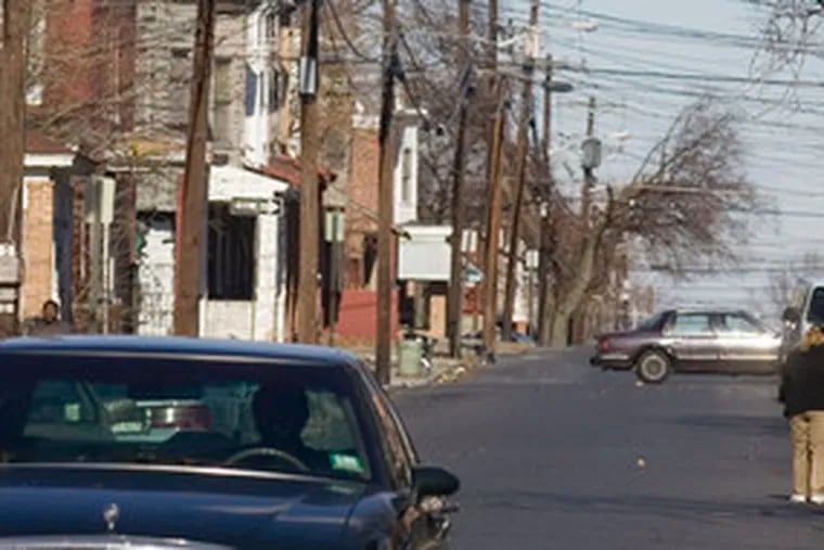 A car heads south on Camden&#0039;s Louis Street, where soon that will be the only direction to go. Residents of the Whitman Park neighborhood and city police believe the change to one-way will restrict access by troublemakers and improve safety.