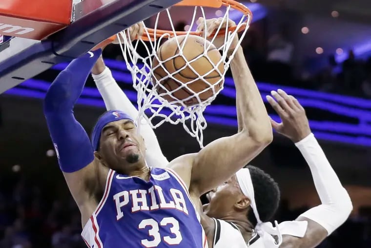 Tobias Harris (33) dunks the ball against the Nets as Chester native Rondae Hollis-Jefferson defends in the third quarter.