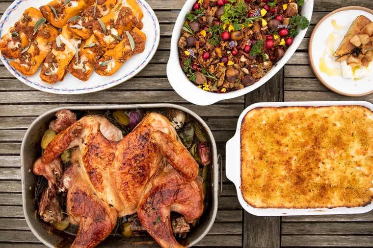 A South Philly chef Thanksgiving spread: (clockwise from top) honeynut squash with stracchino cheese, 'Nduja vinaigrette, and candied pumpkin seeds; aromatic sausage stuffing loaded with garnishes; spiced apple almond cake with brown butter whipped cream; Italian mac and cheese; and spatchcocked turkey over roasted vegetables.
