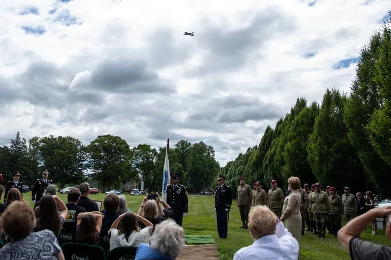 A Whiskey 7 C-47 warplane flies over the funeral service for Leslie Palmer Cruise Jr. at Whitemarsh Memorial Park and Cemetery in Ambler Saturday.