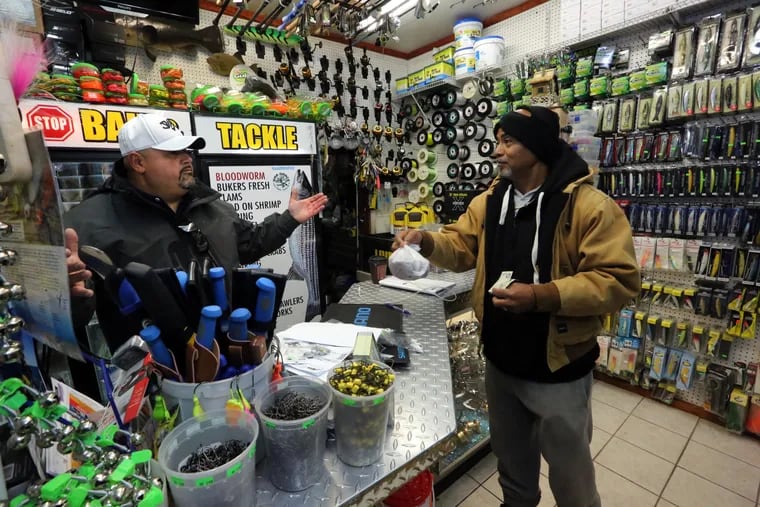 Noel Feliciano , left, owner of One Stop Bait and Tackle, chats with Aaron Foster, of Lumberton, who was buying bait at the shop in Atlantic City,  Friday, Oct. 18, 2019.  VERNON OGRODNEK / For The Inquirer