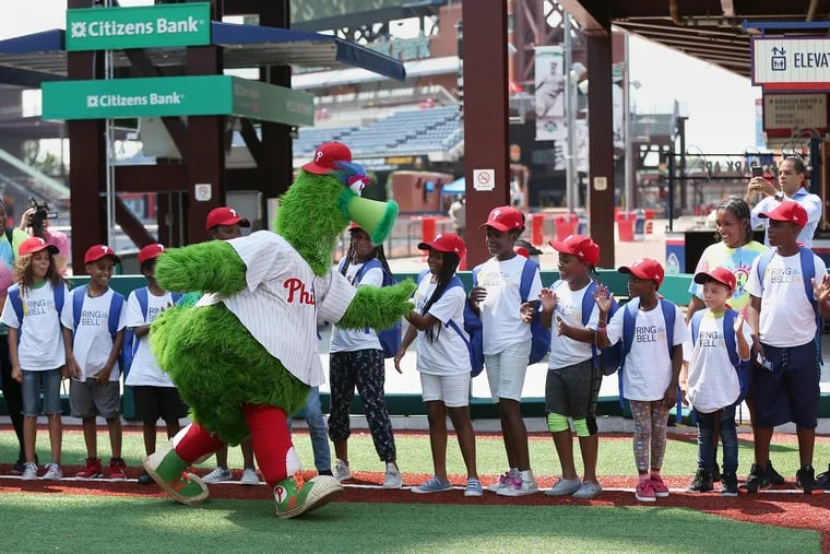 The Phillie Phanatic greets elementary-age students during a news conference promoting the School District of Philadelphia's earlier start date this year at Citizens Bank Park in South Philadelphia on Wednesday, Aug. 15, 2018. The district's first day of class will be Aug. 27. TIM TAI / Staff Photographer