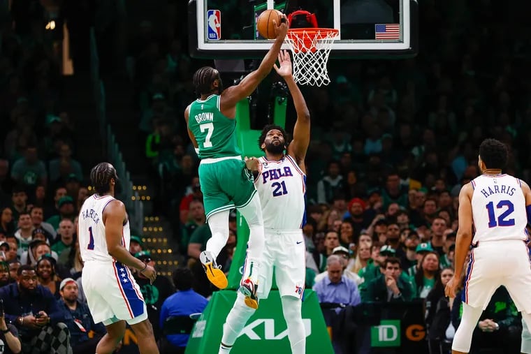 Boston Celtics guard Jaylen Brown scores past Philadelphia 76ers center Joel Embiid in the first quarter during Game 2 in the NBA basketball Eastern Conference semifinals playoff series at TD Garden, Wednesday, May 3, 2023, in Boston.