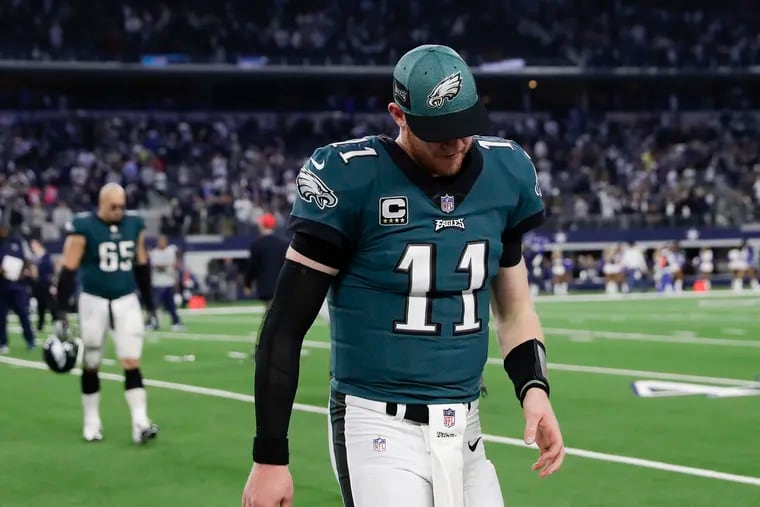 Carson Wentz walks off the field after the Eagles lost to the Cowboys in overtime Sunday in Dallas.