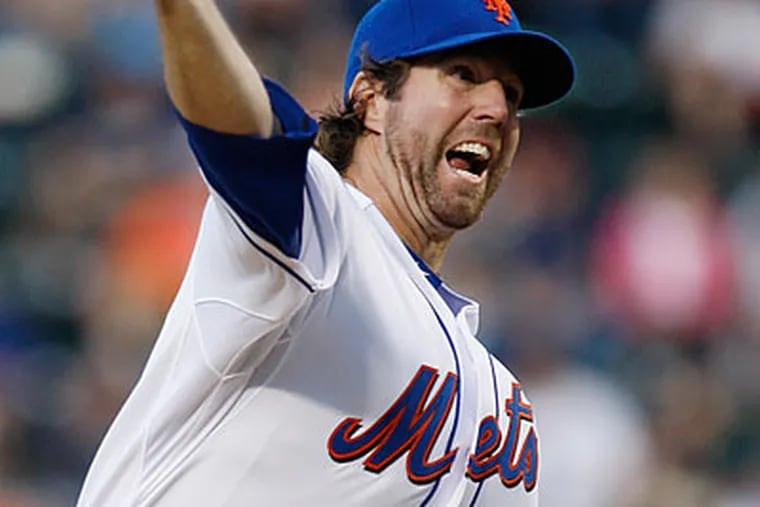 R.A. Dickey threw six shutout innings in the Mets' win over the Phillies. (Kathy Willens/AP)