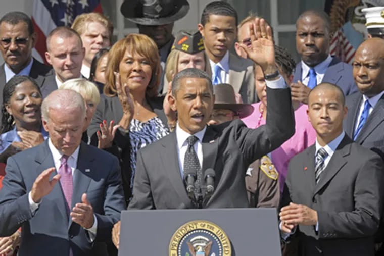 President Barack Obama, accompanied by Vice President Joe Biden, and others, talks about his American Jobs Act during a statement in the Rose Garden of the White House in Washington on Monday. (Susan Walsh / AP Photo)