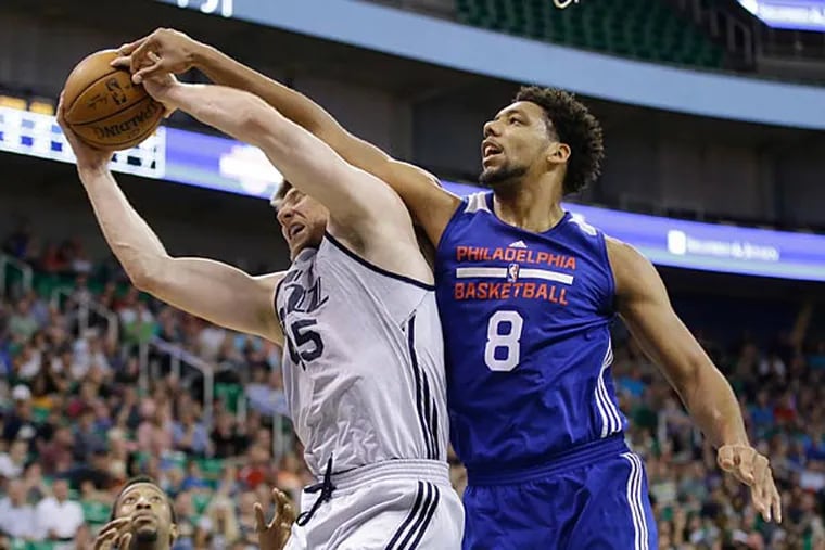 Utah Jazz's Jack Cooley (45) pulls down a rebound in front of Philadelphia 76ers' Jahlil Okafor (8) during the second half of an NBA
summer league basketball game Thursday, July 9, 2015, in Salt Lake
City. The Jazz won in overtime 84-78. (Rick Bowmer/AP)