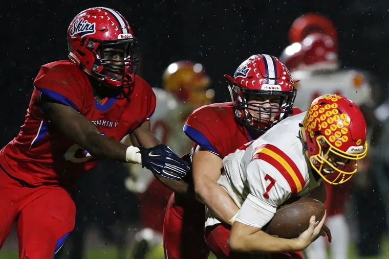 Neshaminy's Tyler Foster (center) and Chisom Ifeanyi (left) sack Haverford High's Jake Ruane in the second quarter.