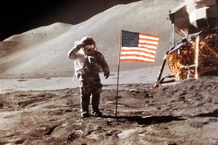 FILE - In this July 30, 1971 photo made available by NASA, Apollo 15 Lunar Module Pilot James B. Irwin salutes while standing beside the fourth American flag planted on the surface of the moon. On Tuesday, March 26, 2019, Vice President Mike Pence called for landing astronauts on the moon within five years. (NASA via AP)