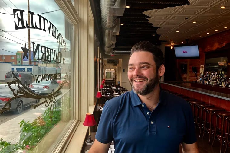 Andrew "Drew" Abruzzese in the window of Pineville Tavern's Philadelphia location in 2018. It closed in early 2019.