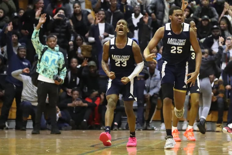 Tvon Jones (left) and Naadhir Wood,of Math, Civics and Sciences celebrate after a 3-point shot by Tayshon Nixon in overtime of victory over Imhotep Charter in Philadelphia Public League semifinal.