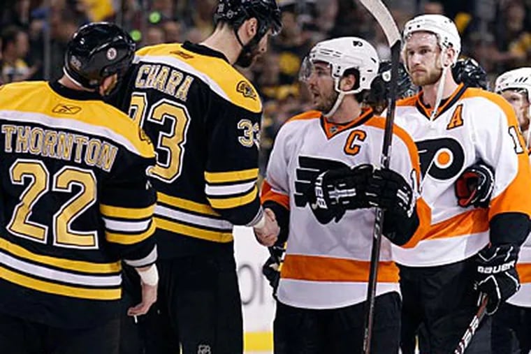 Flyers captain Mike Richards and Bruins captain Zdeno Chara shake hands after Game 4. (Yong Kim/Staff Photographer)