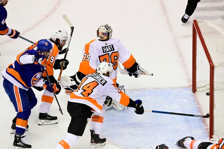 Carter Hart (79) looks back as the puck crosses the goal line on a shot by New York Islanders center Leo Komarov during the second period.