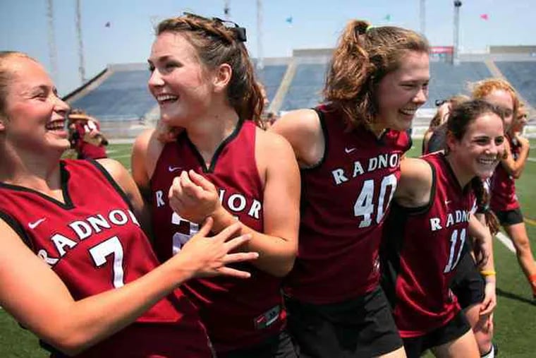 (From left) Molly Samson, Leah Gallagher, Moira Mahoney, and Anny Junior celebrate after defeating Springfield of Delaware County, 14-7, in the PIAA state championship game at HersheyPark Stadium. It was the third time Radnor (26-1) has beaten Springfield-Delco (22-3) this season.
