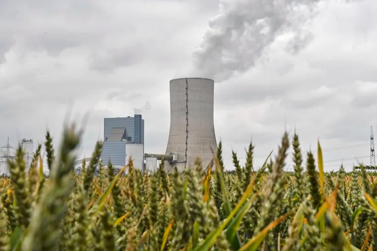 The controversial most modern Uniper Datteln 4 coal-powered plant steams behind a corn field one month after the operational start in Datteln, Germany, Friday, July 3, 2020.