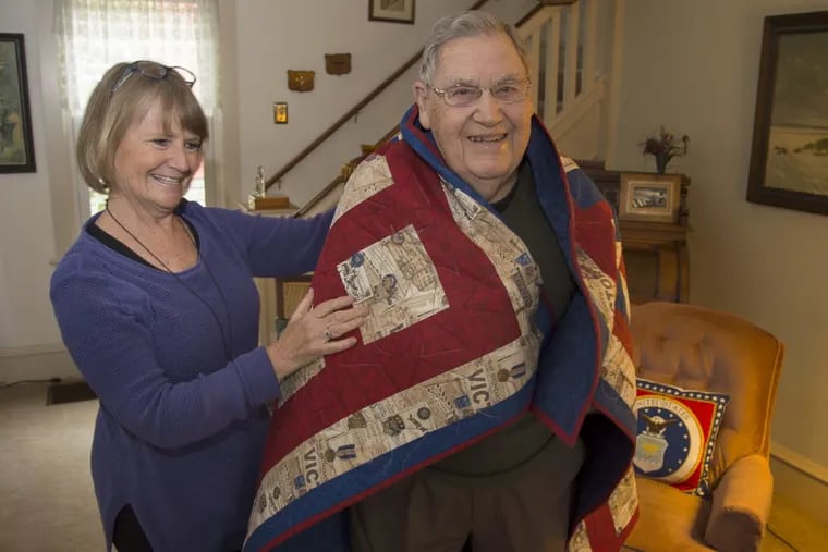Charles Osborne, 93,  a veteran of the Army Air Force in World War II,  with his daughter Patricia “Patt” at his Laurel Springs home. He is wrapped in a Quilt of Valor, an honor he recently received for his wartime service.