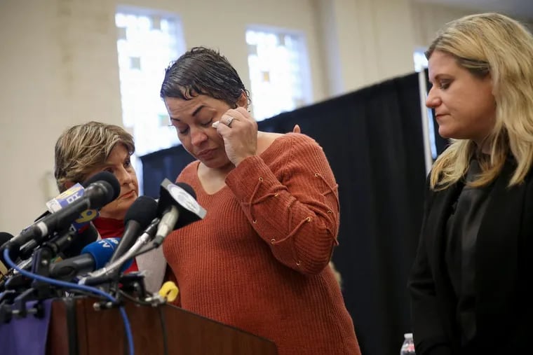 Bill Cosby accuser Chelan Lasha becomes emotional during a news conference with several other accusers, attorney Gloria Allred, left, and Pennsylvania victim advocate Jennifer Storm, right, at Savior Hall in Norristown Pa., on Tuesday, Sept. 25, 2018. Cosby was sentenced to prison for sexually assaulting Andrea Constand.