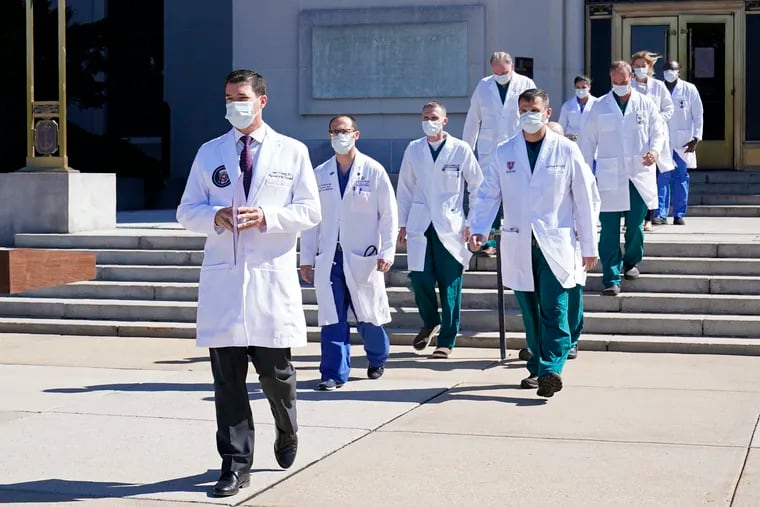 Dr. Sean Conley, physician to President Donald Trump, is followed by a team of doctors for a briefing with reporters at Walter Reed National Military Medical Center in Bethesda, Md., Saturday, Oct. 3, 2020. Trump was admitted to the hospital after contracting the coronavirus.