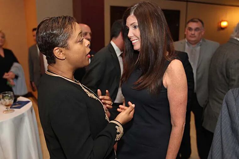 Pennsylvania Attorney General Kathleen Kane, (right), talks with Philadelphia City Councilwoman Cindy Bass, (left), at Kane's campaign fundraiser at the Fraternal Order of Police Hall in the Northeast Wednesday night. ( MICHAEL BRYANT / Staff Photographer )