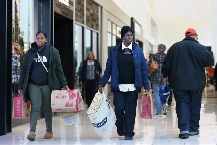 Malayha Hardman, left, and her mother, Charlene Riddick, of Camden, do their Christmas shopping at Cherry Hill Mall in Cherry Hill just days before Christmas. Malls did very well this past holiday shopping season thanks in part to the cold weather.