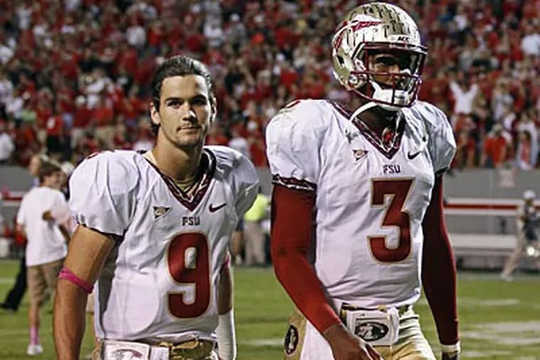 Florida State's Clint Trickett (9) and EJ Manuel (3) leave the field following the loss to North Carolina State. (Gerry Broome/AP)